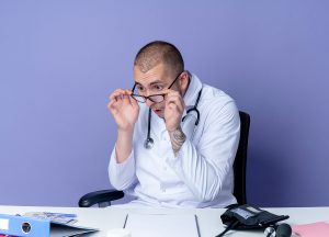 A physician sitting at his desk going through mental burnout