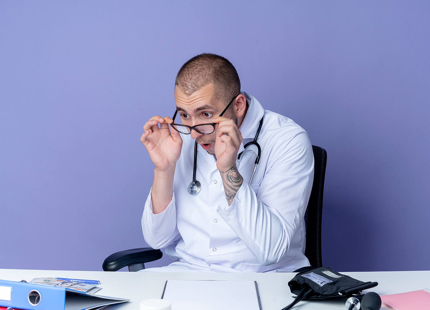 A physician sitting at his desk going through mental burnout